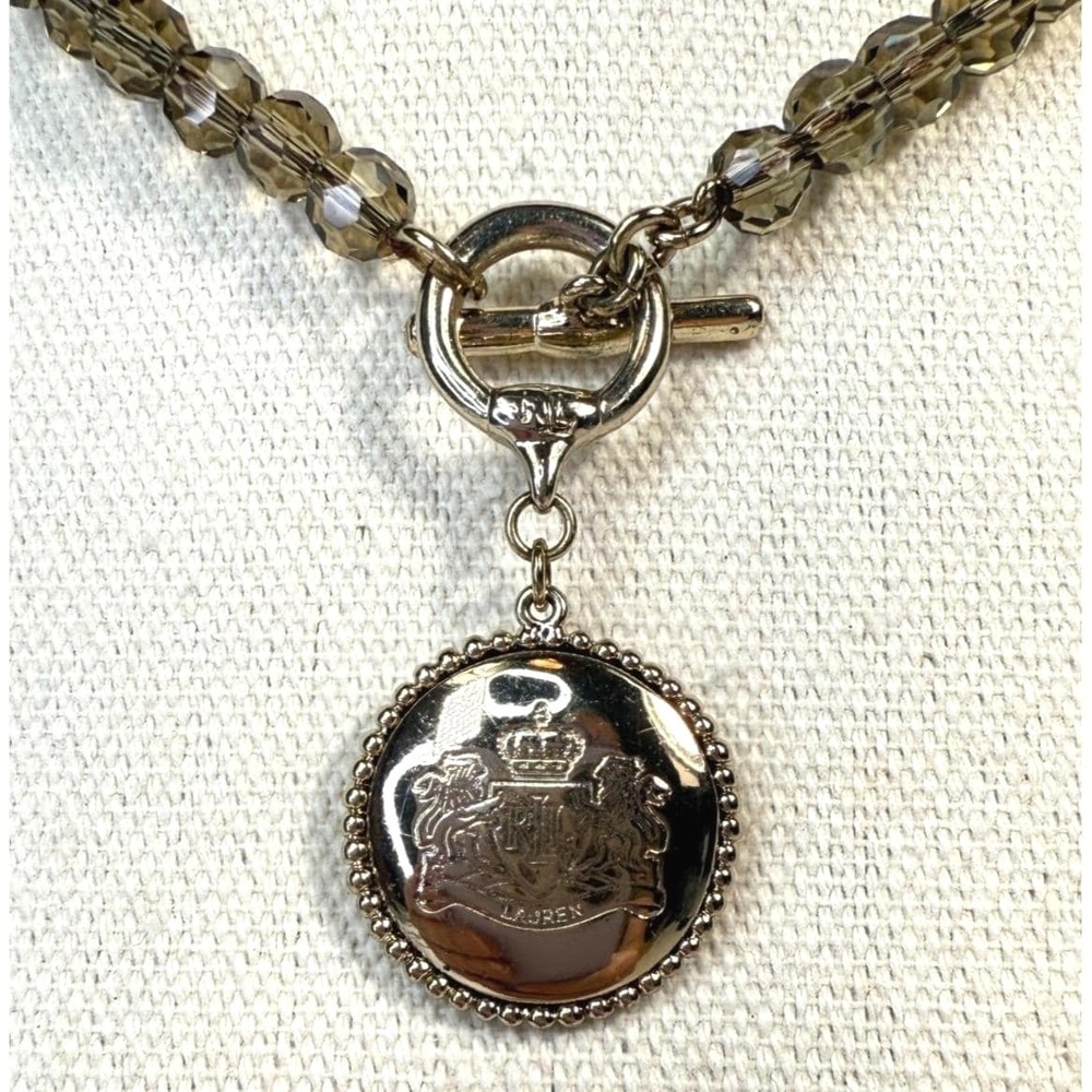 Juicy Couture Gold Tone Crest Medallion Smoky Brown Beaded Toggle Necklace